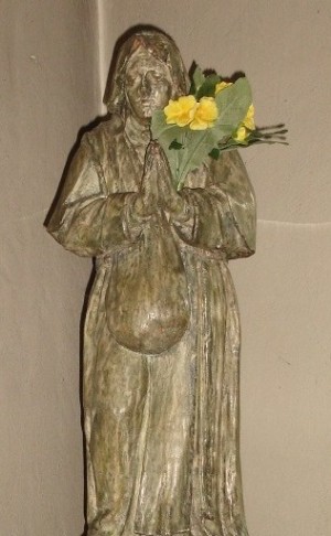 Estatua de la Beata en su capilla de Woluwe, en su iconografía más habitual: portando su alforja para limosnas.